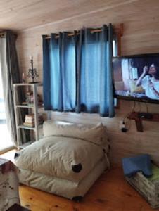 - une chambre avec un lit et une fenêtre avec des rideaux bleus dans l'établissement Desconectate, à Balneario Argentino