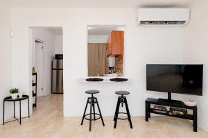 cocina con encimera y taburetes en una habitación en Casa Luquillo, en Fajardo