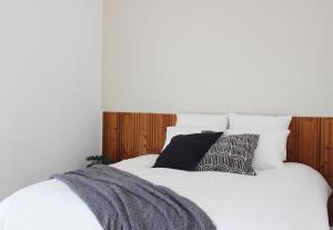 a bed with white sheets and pillows on it at Soar Home I EUA I in Lisbon