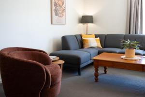 a living room with a couch and a coffee table at Basedow Units Tanunda in Tanunda