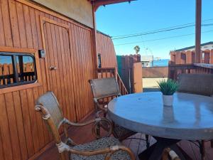 a table and chairs sitting on a porch with a table at Sunset Trailer Park RV #1 in El Suazal