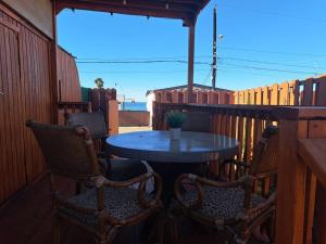 a patio with a table and two chairs on a porch at Sunset Trailer Park RV #1 in El Suazal