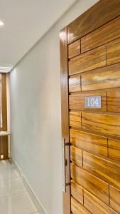 a wooden door in a room with a sign on it at AP alto da serra Villas 104A in Bananeiras