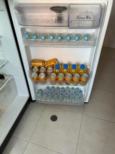 an open refrigerator filled with lots of water bottles at Quien lo vive es quien lo goza in Barranquilla