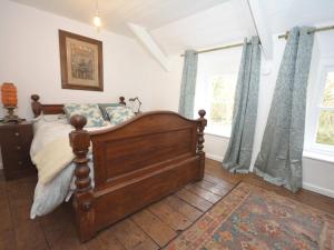 a bedroom with a bed and two windows at 3 Bed in Aberaeron 55308 in Ciliau-Aeron