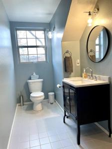 a bathroom with a toilet and a sink and a mirror at The Barn at Emigrant Creek in Ashland