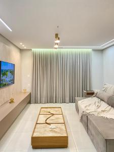 a bedroom with a bed and a table at AP alto da serra Villas 104A in Bananeiras