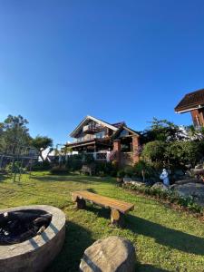 a backyard with a fire pit and a house at Casa Valle Verde in Baguio