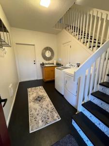 a laundry room with a staircase and a washer and dryer at The Barn at Emigrant Creek in Ashland