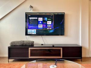 a flat screen tv hanging on a wall at The Barn at Emigrant Creek in Ashland