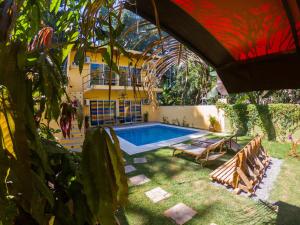 a swimming pool in the backyard of a house at Habitacion privada con pisicina y cocina compartida in Sayulita