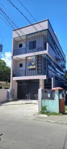a building with a parking garage in front of it at Lorraine Suites in Borongan