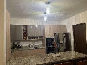 a kitchen with a refrigerator and a counter top at Casa Ros in Bucerías