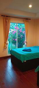 een slaapkamer met een bed en een groot raam bij ํYada Resort Koh Yao Noi in Ko Yao Noi