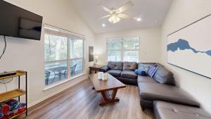a living room with a couch and a table at Water Haus in Fourth Crossing