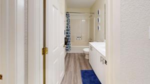 a bathroom with a white toilet and a sink at Water Haus in Fourth Crossing +27 photos