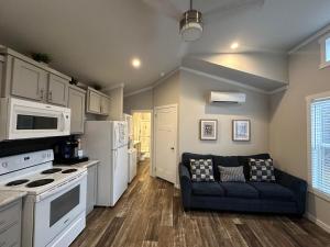 a living room with a couch and a kitchen at Charming New 1-BA/1-BR Home on an 60 Acre Property (Sleeps Up To 4) in Sardis