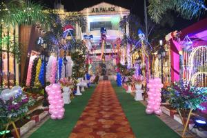 a aisle with pink and purple balloons and flowers at Virat Palace in Deoghar
