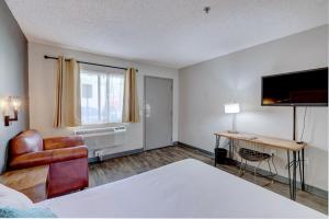 a hotel room with a bed and a desk at The Infusion Beach Club in Palm Springs