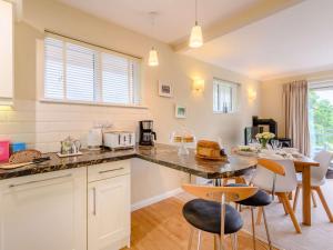 uma cozinha com mesa e cadeiras num quarto em 3 bed property in Godshill New Forest 56431 em Godshill