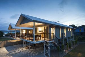 a house with a blue roof and a deck at Island Villas in Thursday Island