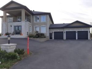 a large house with a parking lot in front of it at King guest apartment in Ottawa