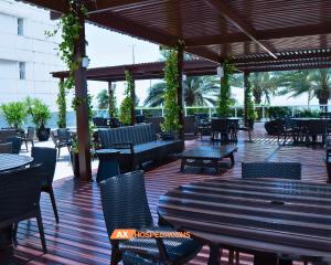 an outdoor patio with tables and chairs and a table at AX Solar Tambaú in João Pessoa