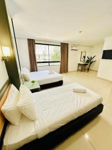 A bed or beds in a room at Swing & Pillows - Corona Inn Bukit Bintang