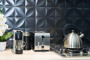 a kitchen counter with a toaster and a tea kettle at Ayres home in Mendoza