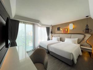 Postel nebo postele na pokoji v ubytování Amethyst Hotel Pattaya + 37 fotografií