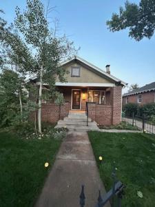 a brick house with a pathway leading to the front door at Excellent Location Mins from Dining & DT! in Denver