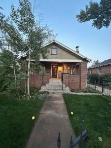 a brick house with a pathway leading to the front door at Excellent Location Mins from Dining & DT! in Denver