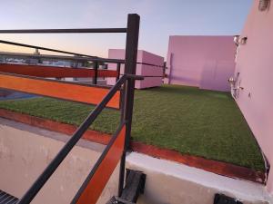 a balcony with green grass on top of a building at Torre del Limay in Neuquén