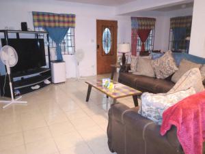 a living room with a couch and a table at Veronica's Tropical Oasis in Christiansted