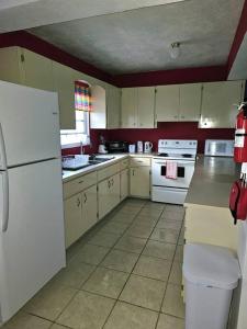 a kitchen with a white refrigerator and white appliances at Veronica's Tropical Oasis in Christiansted