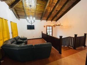 - un salon avec un canapé et une télévision dans l'établissement Las guacamayas House, à Copan Ruinas