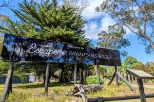 a sign that says escapeinhoarmaarma lodge in a park at Roses Gap View in Dadswells Bridge +9 photos