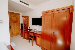 a home office with a desk and a television at Twins Hotel in Ho Chi Minh City