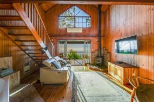 a living room with a couch and a tv in a house at The Polish Place in Mount Tamborine