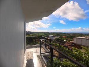 a balcony of a building with a view of the ocean at Cozy73 Ocean View Villa Uluwatu in Uluwatu