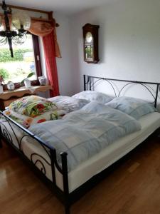 Schlafzimmer mit einem Bett mit blauer Decke in der Unterkunft Herzfenner Hof in Auw