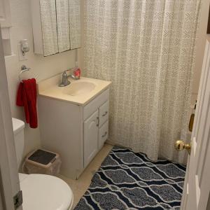 a bathroom with a sink and a toilet and a shower at Nearby Beach House in El Segundo