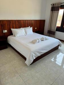 Giường trong phòng chung tại Phouluang Hotel