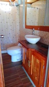 a bathroom with a sink and a toilet and a mirror at Costa Luna in Vichayito