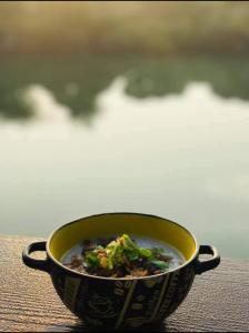 a bowl of soup sitting on top of a table at สวนตุ๊ข้าว(SuanThuKhaw) in Ban Mae Cho