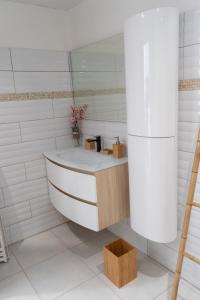 a white bathroom with a tub and a sink at Savanna Sky in Fort-de-France