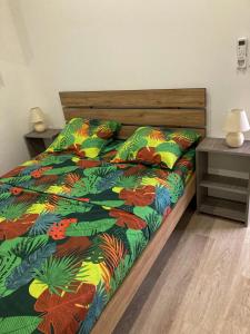a bed with a colorful comforter in a bedroom at Savanna Sky in Fort-de-France