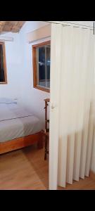 a bedroom with a bed and a window at Costa Luna in Vichayito