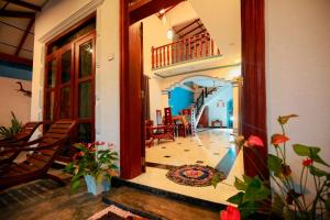 a hallway of a house with a staircase and a living room at Bakini Villa - Ahangama in Ahangama
