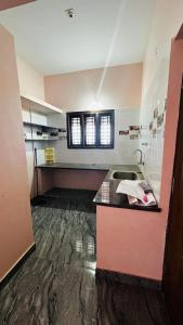 a bathroom with a sink and a counter top at Lekkya service Appartment in Chikmagalūr